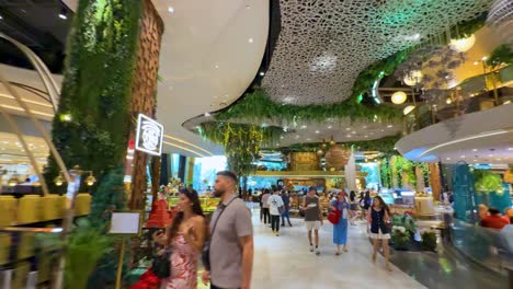 shoppers explore a lively, modern shopping center