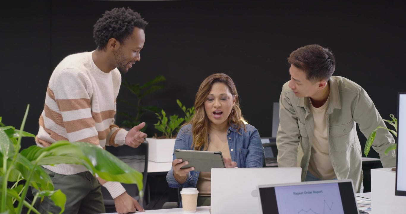 Diverse Team Collaborating on Project in Modern Office