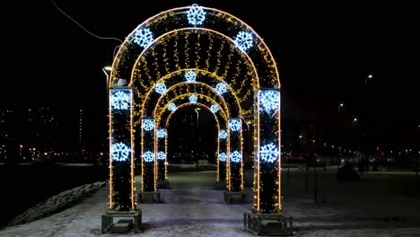 illuminated archway in a city park at night