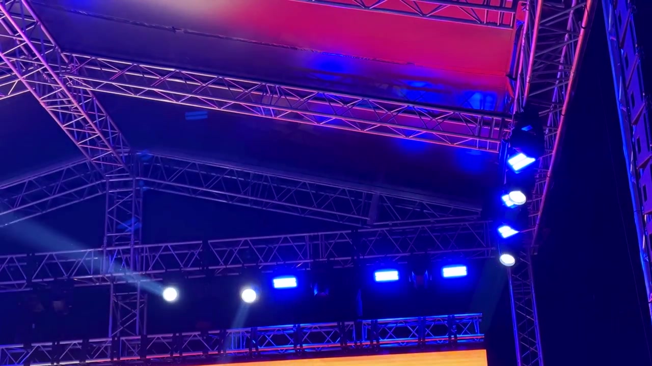 Musical concert performance stage lighting and spotlight beam laser illumination with blue purple colorful rigging truss event show of entertainment festival audience indoor venue in Yerevan Armenia