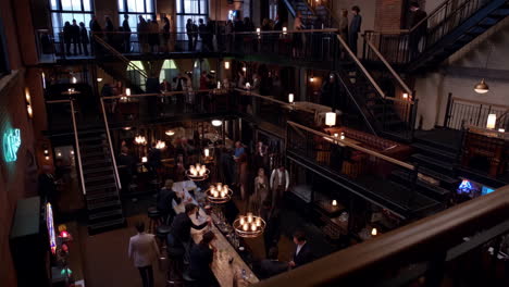 people socializing in a multi-level upscale bar lounge