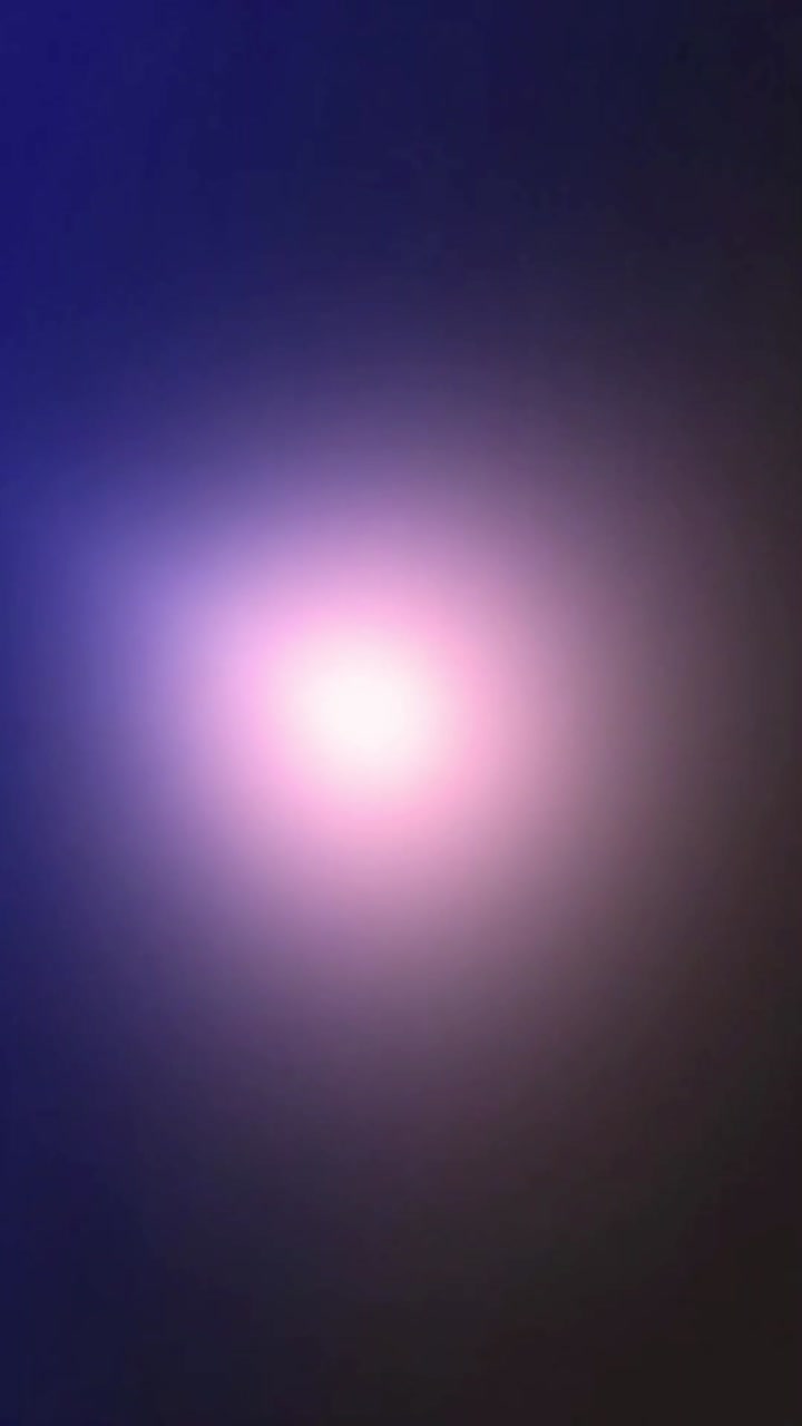 Soft Pink and Purple Lens Flare Effect on Dark Background