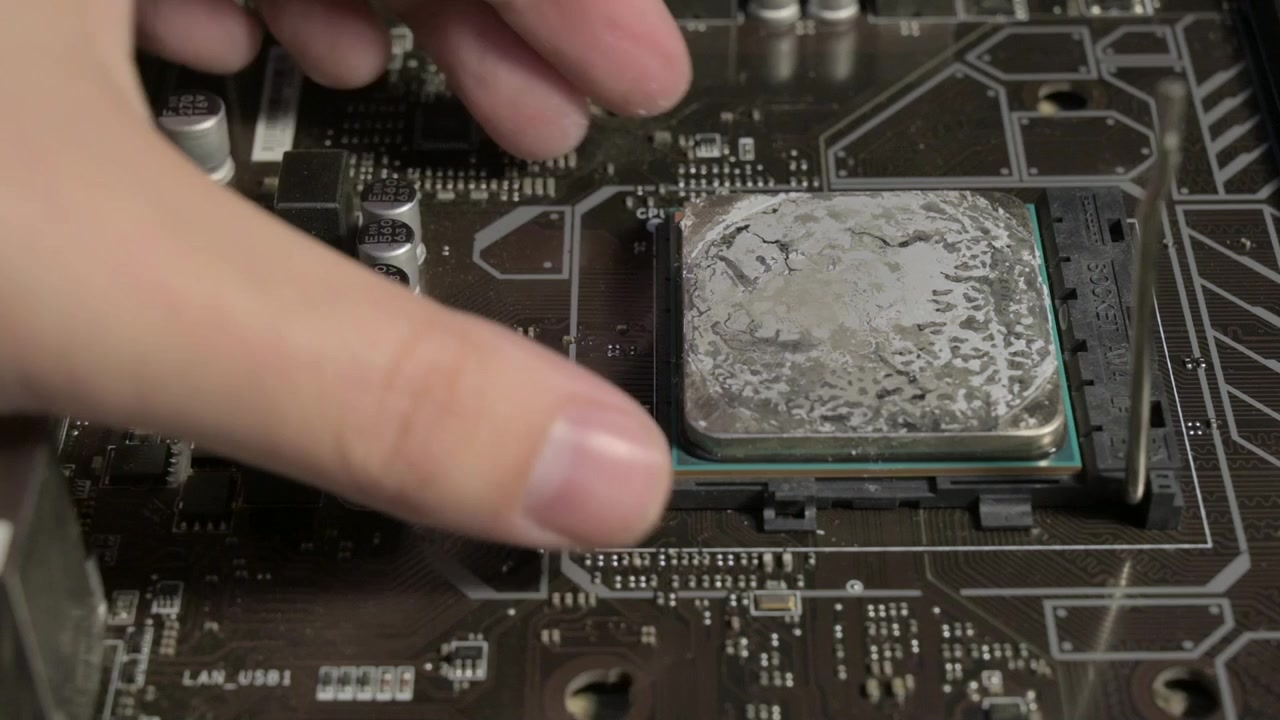 Uninstalling a Processor with Thermal Paste on a Computer Motherboard Circuitry