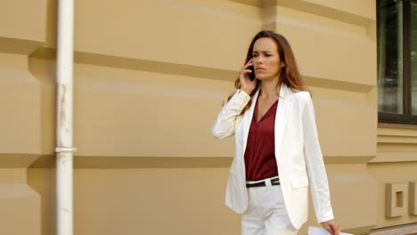 businesswoman talking on the phone in the street