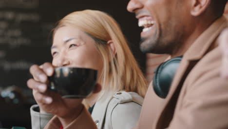 happy group of friends hanging out in coffee shop chatting sharing conversation enjoying socializing having fun in cafe