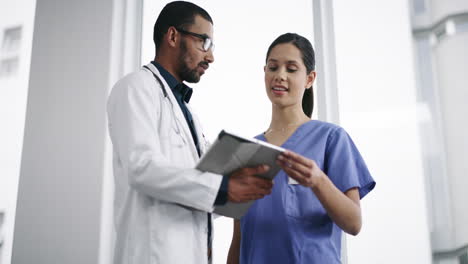 two-doctors-using-a-digital-tablet-in-a-modern