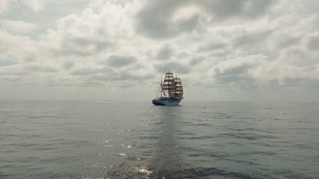 Drone shot of a sailing ship on Atlantischer Ocean on gray, overcast day.