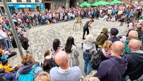 crowd watches performers in lively street show