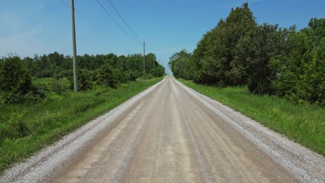 drone flying low on country road in summer