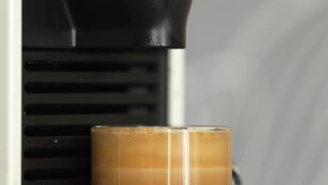 closeup shot of coffee cup being filled up till brim by coffee machine