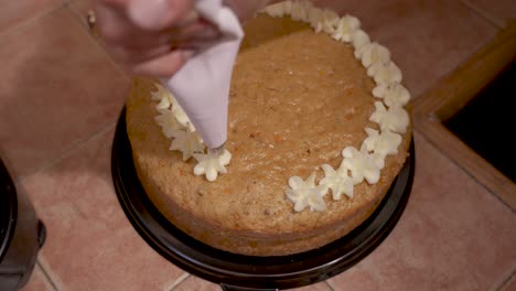 decorating carrot cake with white frost