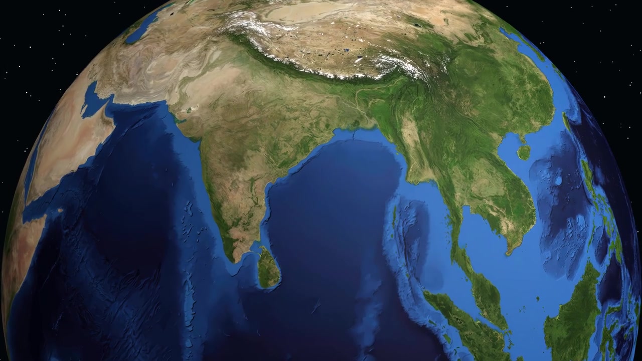 デジタル地球儀が回転し、インドにズームインして、特定の人口データ統計とともにグントゥールを強調する。