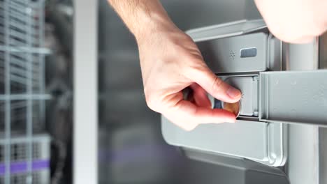 Male-hands-takes-out-Euro-coins-removing-from-dishwasher-box