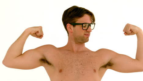 in slow motion geeky hipster showing his muscles