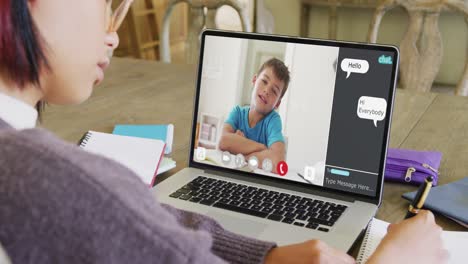 Diverse-female-student-having-class-during-laptop-video-call-with-chat-and-schoolboy-in-slow-motion