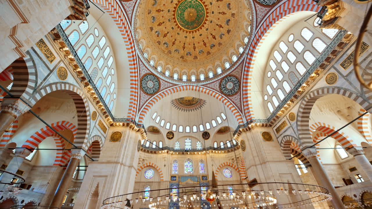 Interior view of the Suleymaniye mosque in Istanbul, Turkey. A lot of illumination, painted ceiling