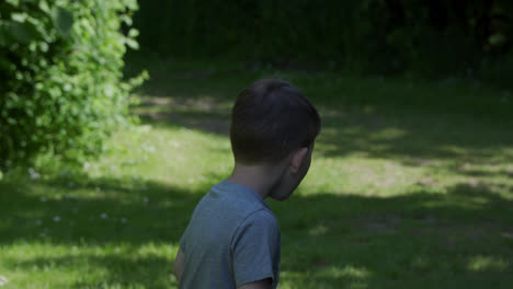 young boy running and laughing whilst playing in the countryside