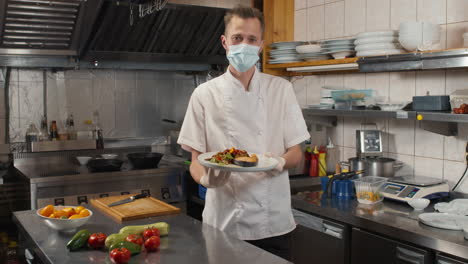 chef in mask with dish on plate