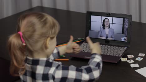 girl distance education lesson with woman teacher, using digital laptop at home