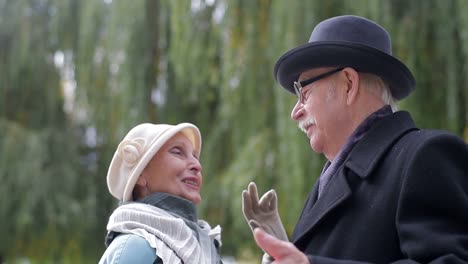 happy elderly couple in conversation outdoors