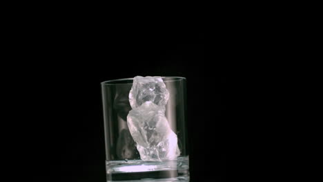 Three-ice-cubes-falling-into-a-glass-