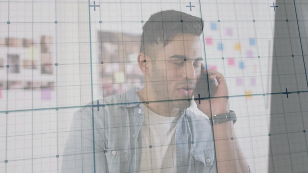 Man holding phone to ear and following work call, grid overlay crossing frame while he reacts