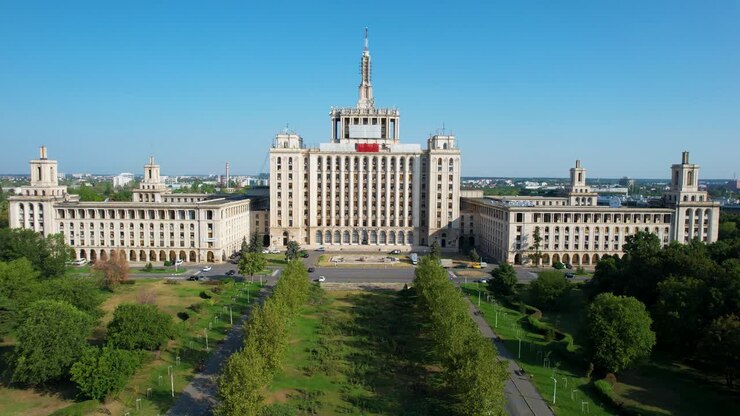 Aerial View Of The House Of The Free Press Building In Bucharest, Romania, Surrounded By Green Vegetation, Sunrise, Clear Blue Sky