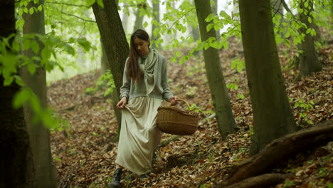 woman hiking in a forest with basket