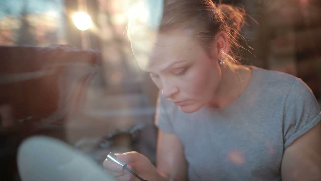 Portrait of a beautiful girl applying mascara to her eyelashes