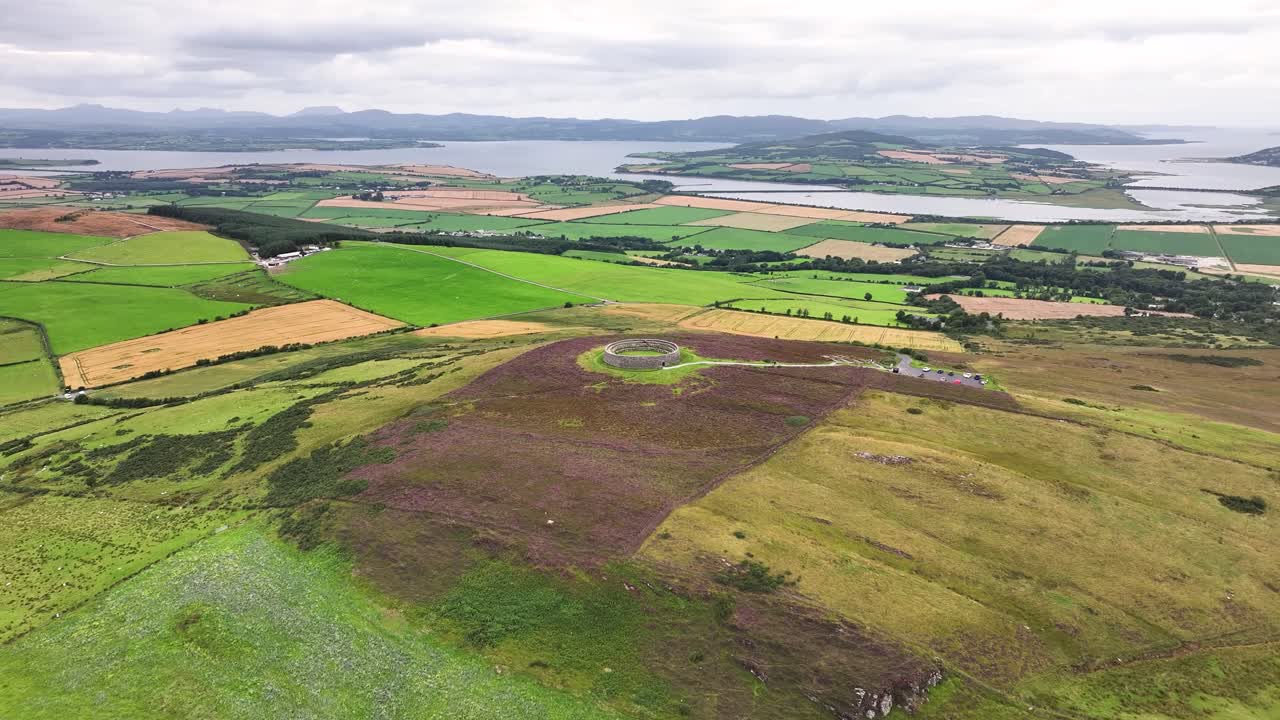 Wide drone shot of Greenan Mountain with round monument on the top. Donegal landscape