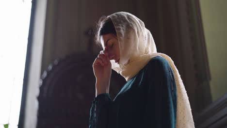 woman praying at the church