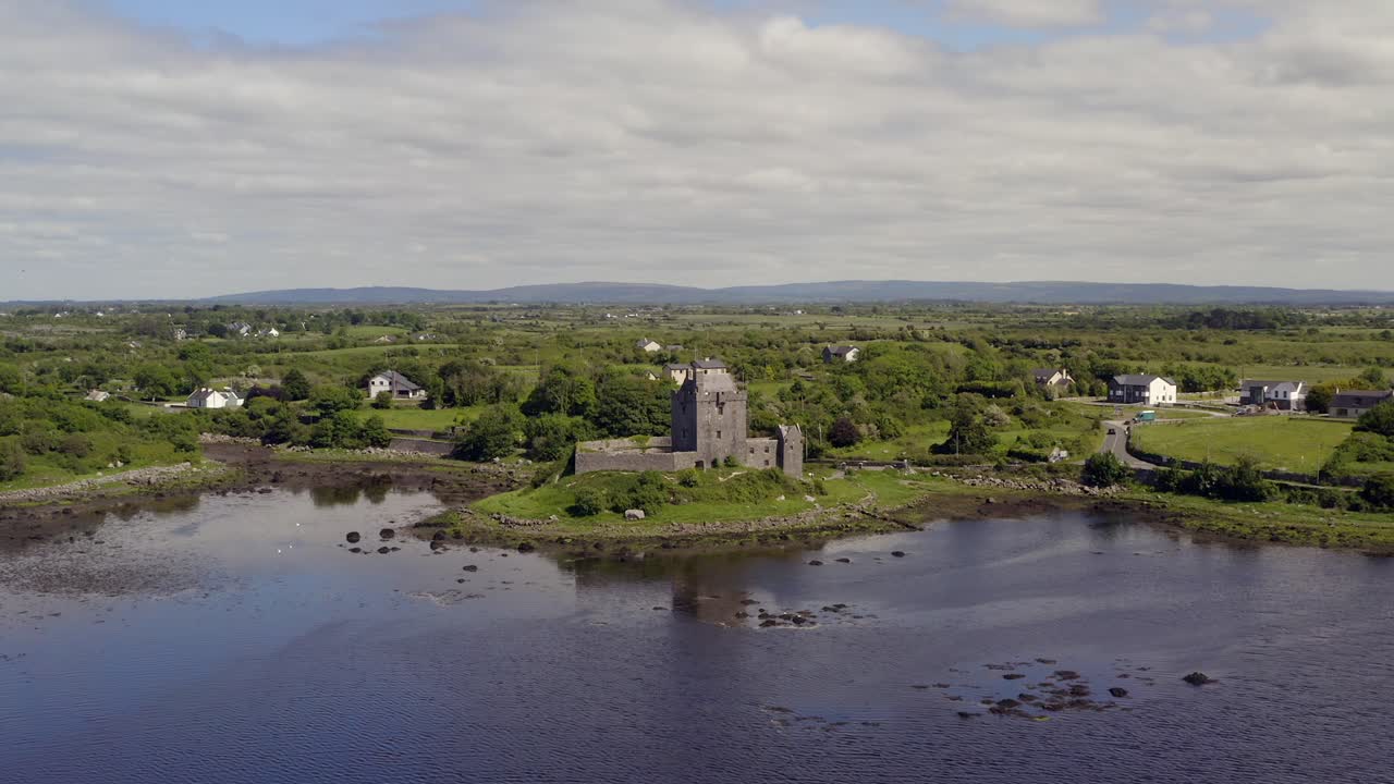 Aerial dolly approaches imposing Dunguaire Castle