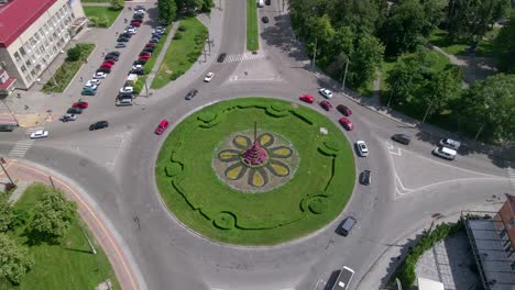 4k aerial view of roundabout road with circular cars in small european city at sunny day