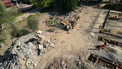 drone view of excavator in city park construction site working