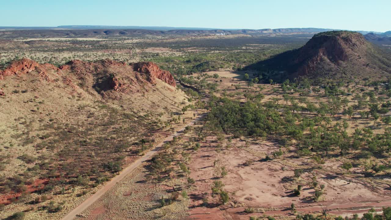 Aerial footage of the MacDonnell Ranges and the dry Roe Creek, in the Northern Territory, Australia. August 2022.