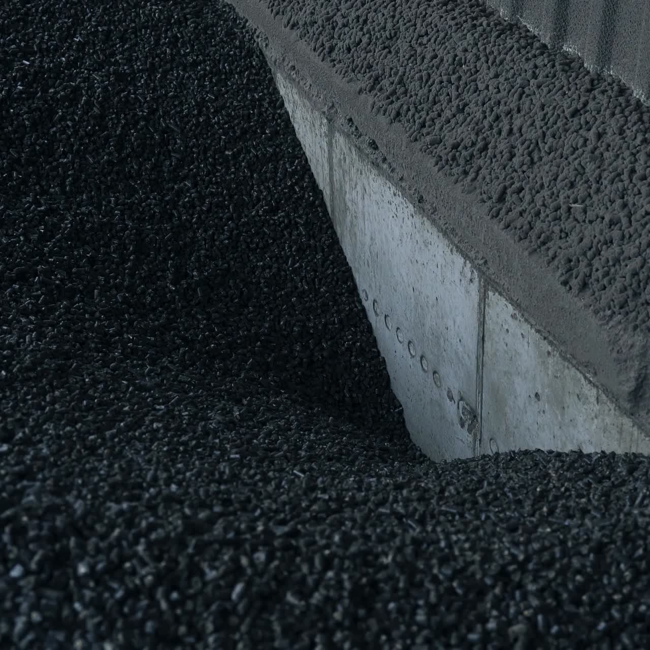 Charcoal storage at the agricultural grain elevator. Black charcoal pieces go down to the hearth to heat the grain storage. Close up