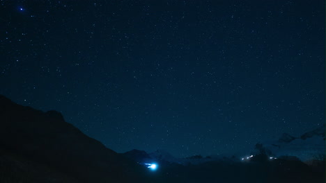 Cinematic-Switzerland-Saas-Fee-Glacier-Gletscher-star-Timelapse-mountain-milky-way-snow-making-cat-track-groomer-lights-up-and-down-the-peak-stunning-clear-deep-blue-evening-night-sky-stunning-still