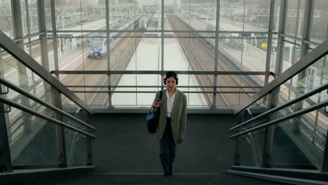 woman walking upstairs at train station