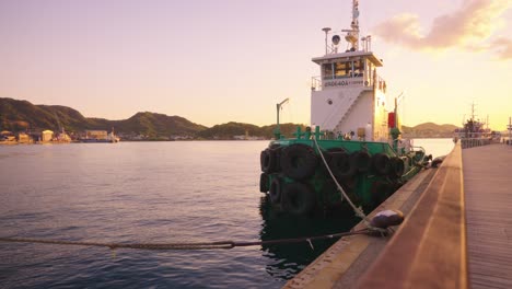 onomichi port, tugboat at pier, sun setting over inland sea of japan 4k
