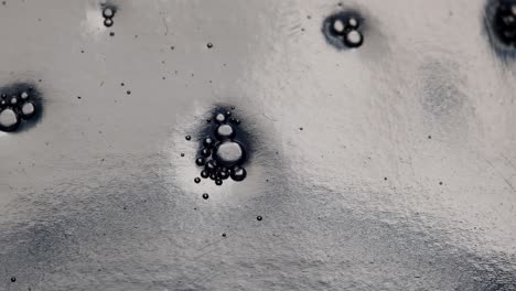 Closeup-of-groups-of-tiny-bubbles-slowly-going-down-inside-a-detergent-bottle