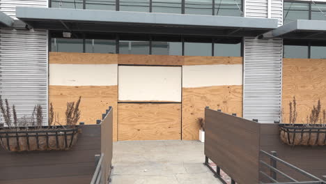 boarded up store front windows due to protests and pandemic