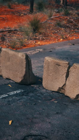 damaged road with concrete barriers in the outback