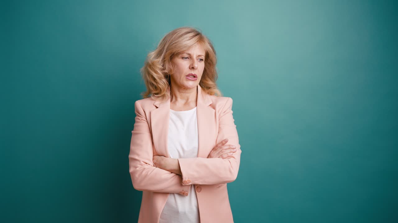 Confused Middle-Aged Woman with Arms Crossed Expressing Doubt