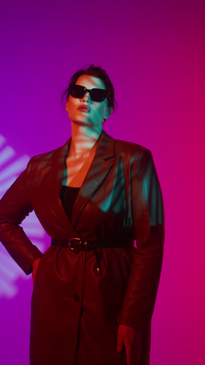 Fashionable woman in leather coat and sunglasses