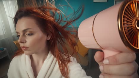 woman drying her red hair
