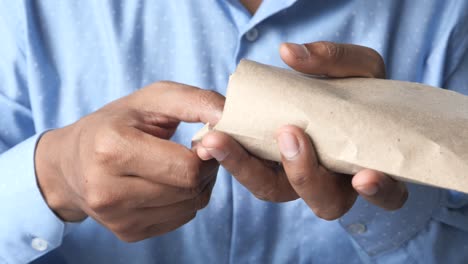 person holding cash in paper bag