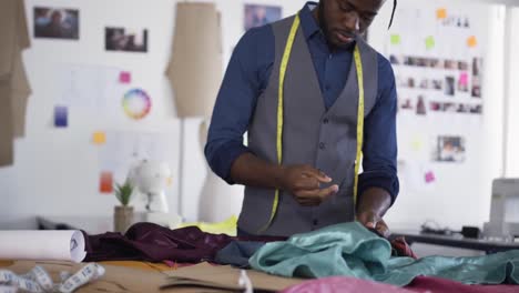 mixed race man working in fashion office