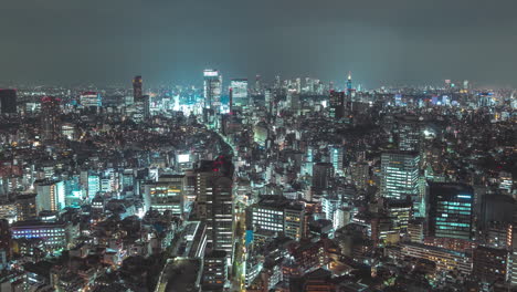 high altitude zoom out timelapse shot of tokyo city japan at night