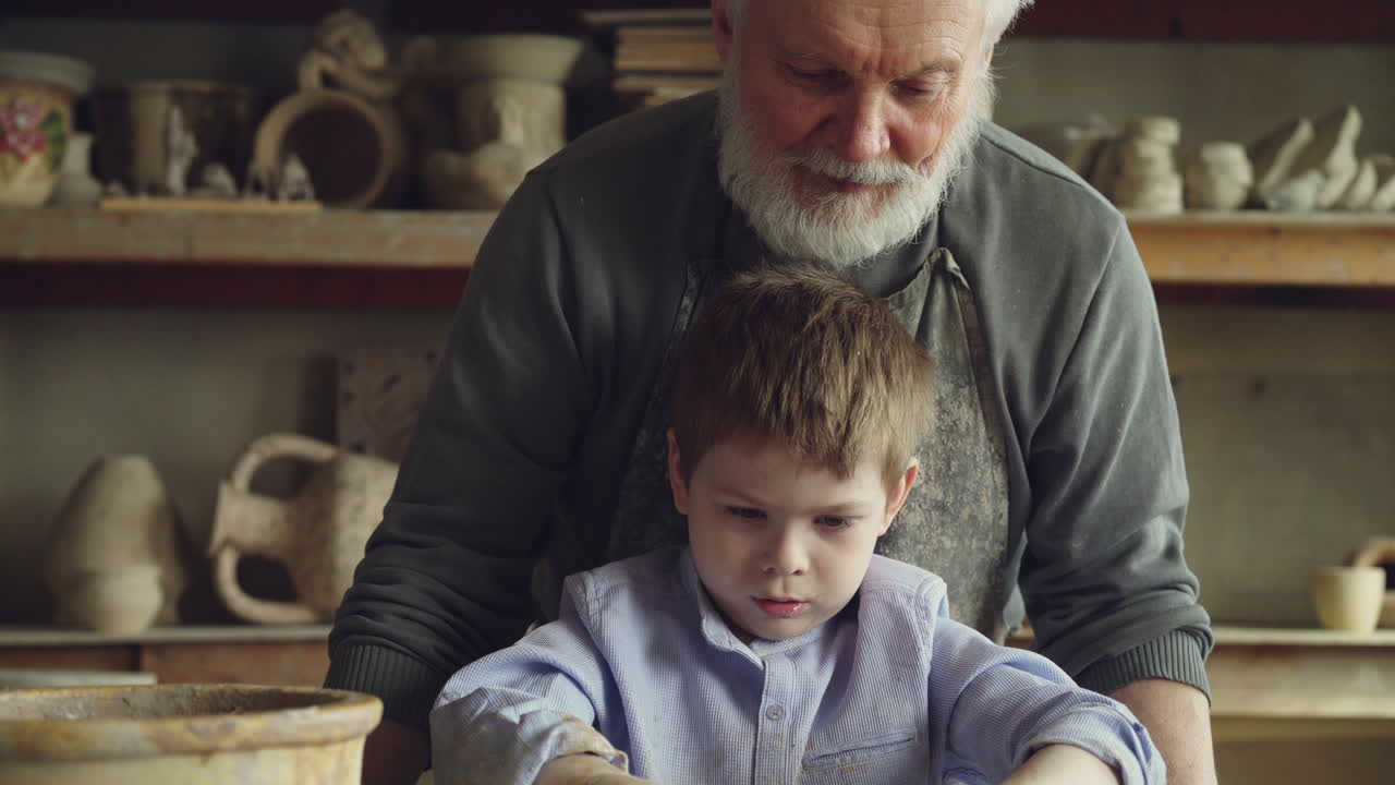 Grandfather and Grandchild Learning Pottery Together
