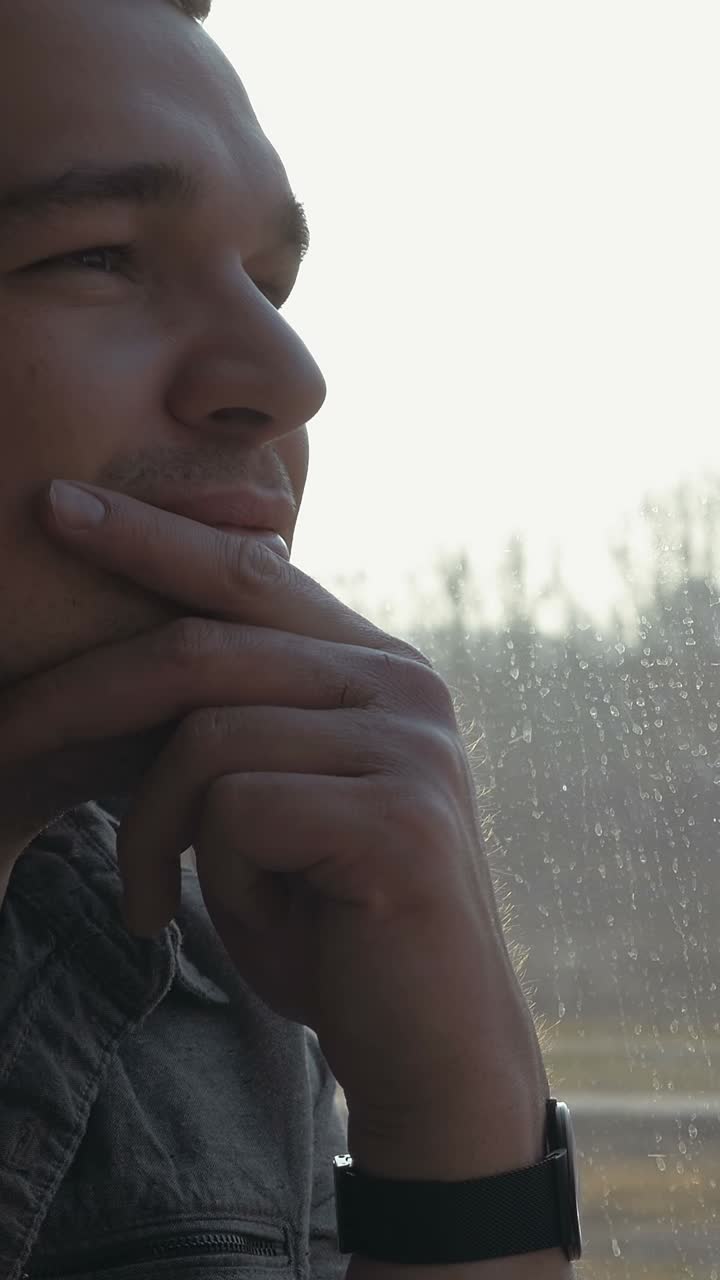 Man Daydreaming by Window